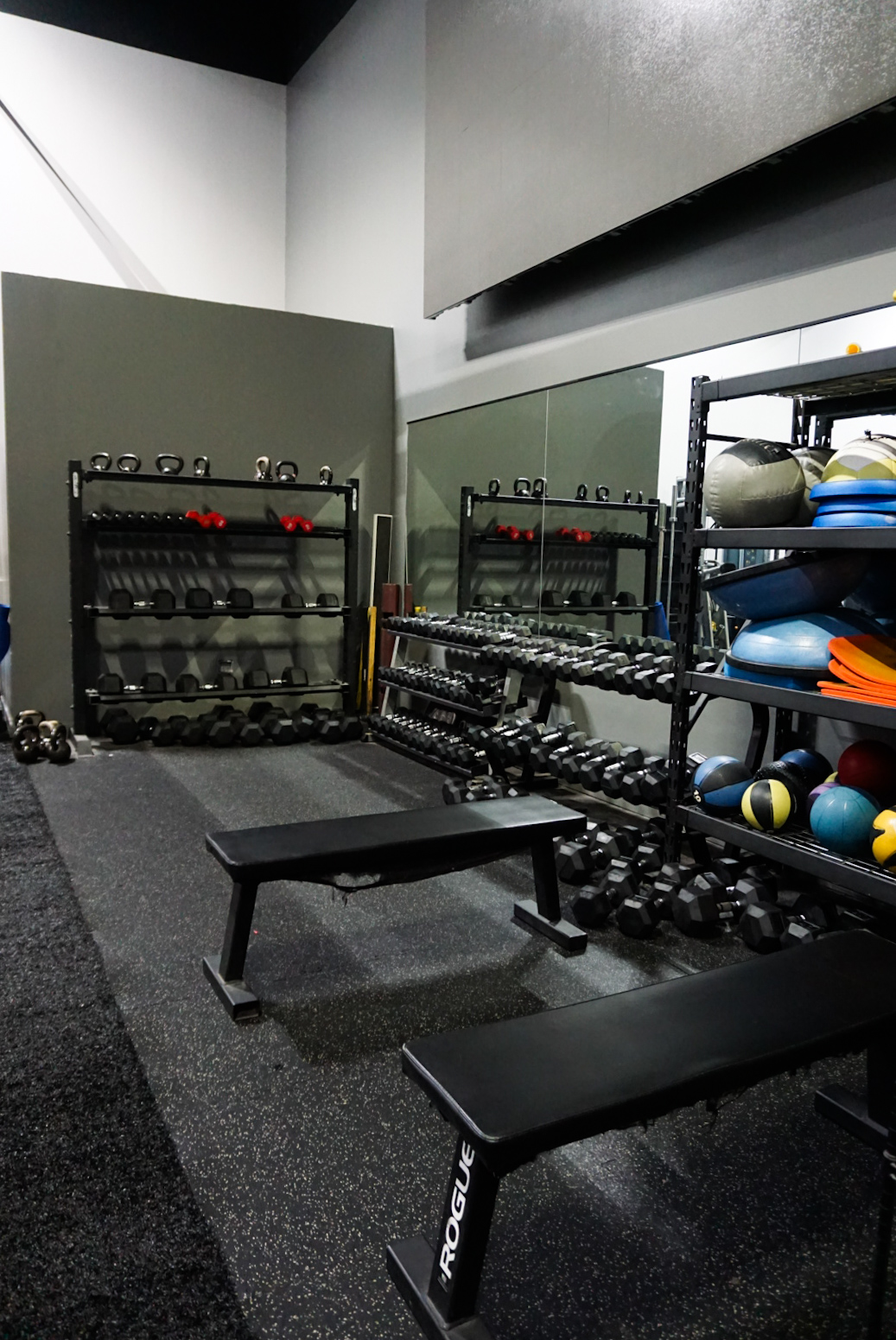 Strength studio with benches, kettlebells, and dumbbells at CIHW
