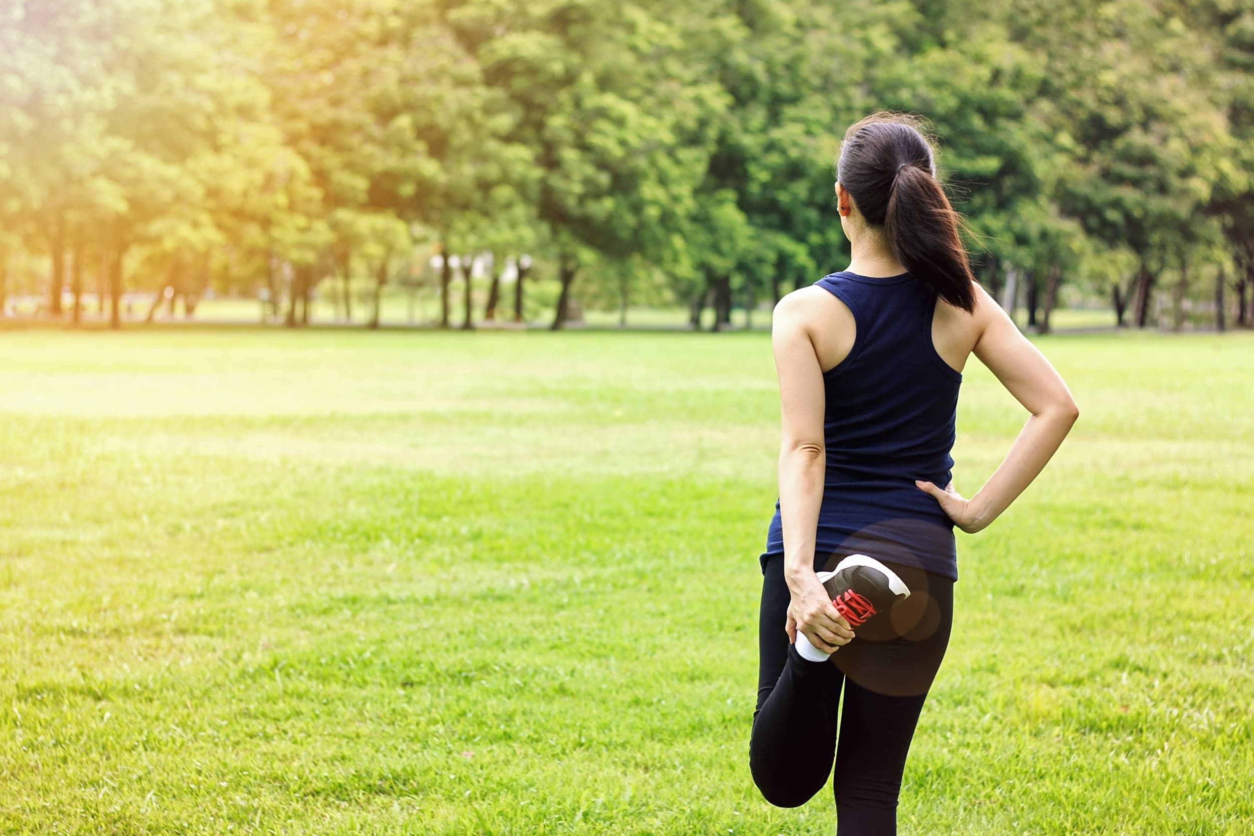 Woman stretching outdoors in late-day light